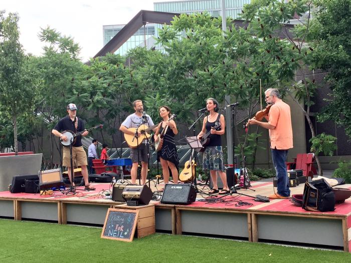 Photo of performing group "Waiting For Neil" on the Plaza Stage