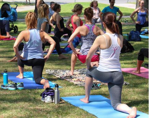 photo of people on an outdoor lawn at Harvard doing Yoga
